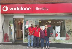  ??  ?? Members of staff outside the Vodafone shop in Hinckley