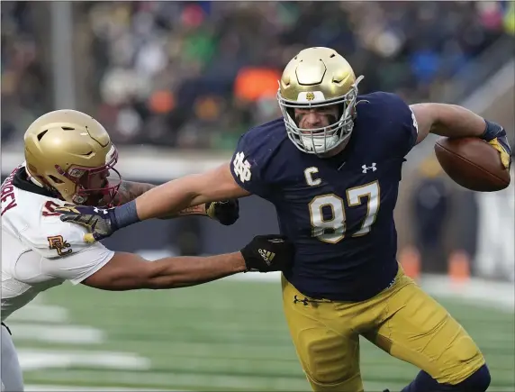  ?? DARRON CUMMINGS — THE ASSOCIATED PRESS ?? Notre Dame tight end Michael Mayer runs past Boston College defensive back Jaiden Woodbey during the first half of a Nov. 19, 2022 game in South Bend, Ind.