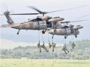  ??  ?? File photo shows Japan Ground Self-Defence Force troops descending from helicopter­s during an annual live-fire exercise at the HigashiFuj­i firing range in Gotemba, at the foot of Mount Fuji in Shizuoka prefecture. — AFP photo