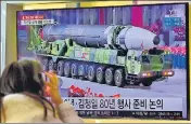  ?? ?? A woman watches a news broadcast with file footage of a North Korean missile, at a railway station in Seoul on Thursday .