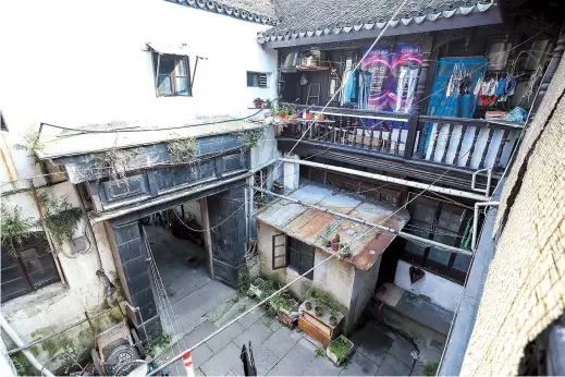  ??  ?? A typical Shanghai stone-gate courtyard house in an alley at Sijing Town. Locals still live in this building but they are waiting to move, as the house will be renovated in the future.