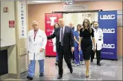  ?? DREW ANGERER / GETTY IMAGES ?? Surgeon Dr. John Fildes (from left), President Donald Trump and first lady Melania Trump walk through University Medical Center in Las Vegas on Wednesday. The Trumps visited victims of Sunday’s mass shooting as well as medical profession­als.