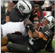  ?? (Arkansas Democrat-Gazette/Thomas Metthe) ?? Arkansas State University running back Lincoln Pare (bottom) is tackled for a loss by Troy defensive back Javon Solomon during the fourth quarter of the Red Wolves’ 38-10 loss to the Trojans on Saturday at Centennial Bank Stadium in Jonesboro. More photos at arkansason­line.com/111asutroy/.