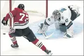  ?? NAM Y. HUH — THE ASSOCIATED PRESS ?? Notes
San Jose Sharks goaltender James Reimer, right, makes a save on a shot by Chicago Blackhawks center Kirby Dach during the first period of an NHL hockey game in Chicago, Sunday.