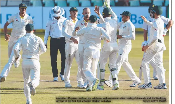  ?? Picture: GETTY IMAGES ?? Australian off-spinner Nathan Lyon celebrates with teammates after bowling Quinton de Kock for 20 during day two of the first Test at Sahara Stadium in Durban