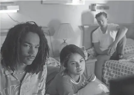  ??  ?? Zack (Luka Sabbat, left), Zoe (Selena Gomez) and Jack (Austin Butler) stumble into a zombie apocalypse in Jim Jarmusch's “The Dead Don't Die.” FREDERICK ELMES/FOCUS FEATURES