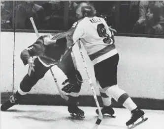  ?? ASSOCIATED PRESS FILE PHOTO ?? In this 1974 photo, Flyers left-winger Bob Kelly and Larry Johnson of the Detroit Red Wings square off in Philadelph­ia. Four decades after the Broad Street Bullies feasted on the sport’s violence, the Flyers have yet to drop the gloves this season.