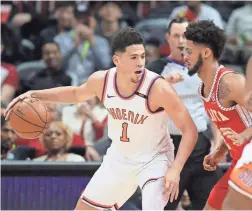  ?? JASON GETZ/USA TODAY SPORTS ?? Suns guard Devin Booker makes a move against Hawks guard Tyler Dorsey during the first quarter at Philips Arena.