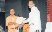  ?? ASHOK DUTTA/HT PHOTO ?? Union minister M Venkaiah Naidu hands over papers regarding release of funds for UP to chief minister Yogi Adityanath in Lucknow on Friday.