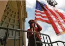  ?? Carlos Avila Gonzalez / The Chronicle 2021 ?? Renée Deeter raises the flag before a Golden Gate Park Band concert.