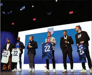  ?? JULIA NIKHINSON / ASSOCIATED PRESS ?? United States soccer players Deandre Yedlin, Shaq Moore, Aaron Long and Walker Zimmerman hold up jerseys Nov. 9 in New York after being introduced announced as defenders on the U.S. men’s national soccer roster for the upcoming World Cup in Qatar.