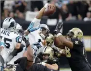  ?? BILL FEIG — THE ASSOCIATED PRESS ?? Carolina quarterbac­k Cam Newton (1) reaches over the pile for a first down during Sunday’s playoff game against the Saints in New Orleans.