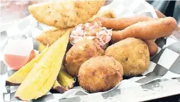  ??  ?? Try the mac and cheese balls, sweet potato wedges, breadfruit fries, fried festival and cabbage slaw.