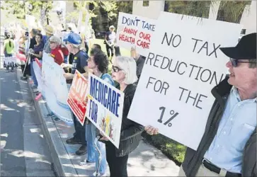  ?? Eugene Garcia European Pressphoto Agency ?? CONSTITUEN­TS concerned about a range of issues protest outside the office of Rep. Darrell Issa in Vista, Calif. On two occasions he surprised demonstrat­ors by coming outside and answering questions.