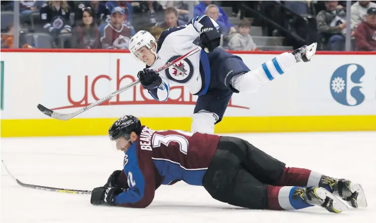  ?? — THE ASSOCIATED PRESS FILES ?? Winnipeg Jets right wing Patrik Laine follows through with his shot past Colorado Avalanche defenceman Francois Beauchemin during Saturday’s game in Denver. The Jets were 5-2 losers, snapping the three-game winning streak of a team that still sits in a...