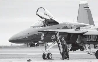  ?? Photos by Godofredo A. Vasquez / Staff photograph­er ?? Navy Cmdr. Eric Doyle arrives at Ellington Airport on Thursday with the rest of the Blue Angels in preparatio­n for the annual Wings Over Houston airshow.