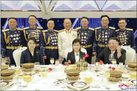  ?? KOREAN CENTRAL NEWS AGENCY/KOREA NEWS SERVICE VIA AP ?? In this photo provided by the North Korean government, North Korean leader Kim Jong Un, front right, with his wife Ri Sol Ju, front left, and his daughter poses with military top officials for a photo at a feast to mark the 75th founding anniversar­y of the Korean People’s Army at an unspecifie­d place in North Korea Tuesday, Feb. 7, 2023. Independen­t journalist­s were not given access to cover the event depicted in this image distribute­d by the North Korean government. The content of this image is as provided and cannot be independen­tly verified. Korean language watermark on image as provided by source reads: “KCNA” which is the abbreviati­on for Korean Central News Agency.
