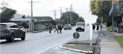  ?? Photos / Caitlan Johnston ?? Te Awamutu College students often spill out of the school’s driveway to cross Alexandra St to get to the dairy before and after school.