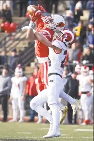  ?? H John Voorhees III / Hearst Connecticu­t Media ?? New Canaan’s Charlie Cunney, right, knocks away a pass intended for Greenwich’s Lance Large on Saturday.
