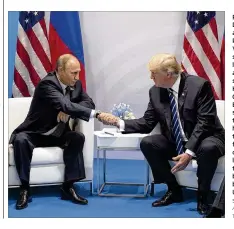  ?? STEPHEN CROWLEY / THE NEW YORK TIMES ?? President Donald Trump and Russian President Vladimir Putin shake hands last month at the G-20 summit in Hamburg, Germany. Before the U.S. sanctions vote, the Kremlin had expected the face-toface meeting of the two leaders to set the stage for better...