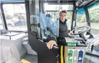  ??  ?? B.C. Transit safety and training officer Sal Ruffolo shows the new door designed to protect bus drivers.