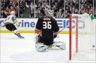  ?? Chris Carlson ?? The Associated Press Golden Knights defenseman Shea Theodore, left, watches his first-period shot zip past Anaheim Ducks goaltender John Gibson, tying Wednesday’s road game at 1-1. The Knights finished strong, winning 4-1 against their division rivals.