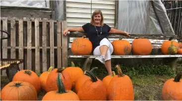  ??  ?? Madeleine chills out in Connecticu­t with the fruits of the pumpkin patch