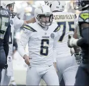  ?? Luis Sinco Los Angeles Times ?? CALEB STURGIS is congratula­ted by teammates after making an extra-point try for the Chargers.