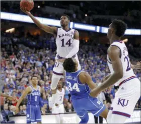  ?? CHARLIE NEIBERGALL - THE ASSOCIATED PRESS ?? Kansas’ Malik Newman (14) is fouled on his way to the basket by Duke’s Wendell Carter Jr (34) during overtime of a regional final game in the NCAA men’s college basketball tournament Sunday, in Omaha, Neb.