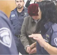  ?? (Ronen Zvulun/Reuters) ?? MALKA LEIFER escorted into Jerusalem District Court during extraditio­n proceeding­s in 2018.