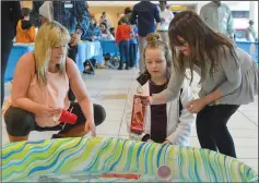  ?? NEWS PHOTOS MO CRANKER ?? Left: Krista Osgood, Reese Osgood and Kaydence Caleigh test their boat to see if it will float Saturday.