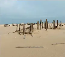  ??  ?? SURVIVOR NAMIBIA (below). Shipwrecke­d sailors from the stricken Dunedin Star waited for weeks before they were rescued. They built wooden structures on the beach for shelter – these frames are all that remain.