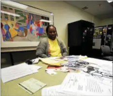  ?? SCOTT KETTERER — THE TRENTONIAN ?? Talaya Greenfield sits before a Trentonian Cafeteria Table with documents and papers related to her slain son on Nov. 6, 2015, during an interview.