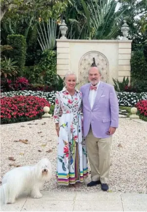  ?? ?? Janie and Allan Jones in their Palm Beach backyard with their dog, a coton de tulear named Henry, who follows Allan Jones everywhere.