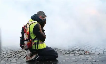  ??  ?? A gilets jaunes protester on the Champs Élysées in Paris. Photograph: Michael Baucher/Panoramic