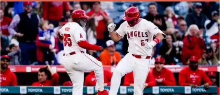  ?? ?? Los Angeles Angels’ Mike Trout (right) celebrates his home run with third base coach Eric Young Sr.