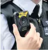  ??  ?? A police officer wearing a body camera