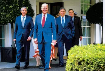  ?? PETE MAROVICH/THE NEW YORK TIMES ?? President Biden leads a bipartisan group of senators out of the White House Thursday.