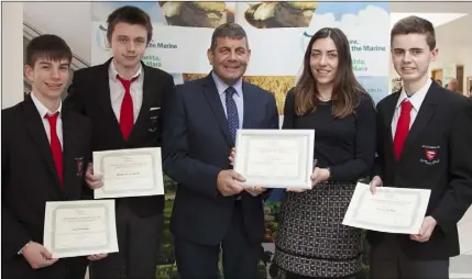  ??  ?? Con O Meachair, Robbie Mac Giolla De, Elaine Nic Reamoinn (teacher) and Connor De Ruit from Meanscoil Gharman receive their certificat­es from Minister of State Andrew Doyle.