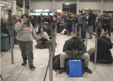 ?? Dan Kitwood / Getty Images ?? Passengers were stranded at London’s Gatwick Airport. Some were forced to land at airports as far away as Paris.
