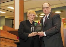  ?? SUBMITTED PHOTO - ELGIN COMMUNITY COLLEGE ?? Kutztown University President Dr. Kenneth S. Hawkinson, right, is presented the Elgin Community College Distinguis­hed Alumni Award from Eleanor MacKinney, chair, Elgin Community College Board of Trustees.