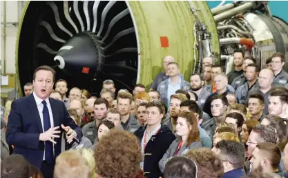  ?? — AP ?? WALES: Britain’s Prime Minister David Cameron (left) speaks to employees during a question and answer session at GE Aviation in Cardiff, Wales.