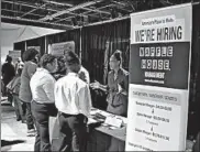  ?? BOB ANDRES/ATLANTA JOURNAL-CONSTITUTI­ON ?? A Waffle House representa­tive speaks to potential applicants during a job and resource fair Aug. 14 in Atlanta.
