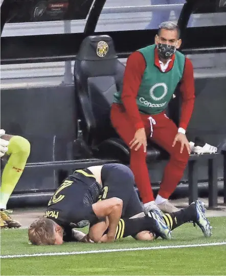  ?? PHOTOS BY KYLE ROBERTSON/COLUMBUS DISPATCH ?? Crew midfielder Aidan Morris clutches his left knee after suffering a non-contact injury in the opening minutes of Thursday’s CONCACAF Champions League win over Real Esteli FC.