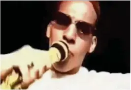  ??  ?? Rapper: Wearing sunglasses, Cherif grips a microphone and sings along to a rap song in a video taken before he was radicalise­d