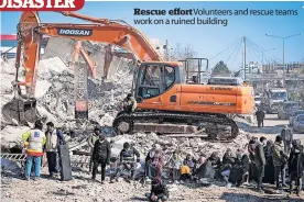  ?? ?? Rescue effort Volunteers and rescue teams work on a ruined building