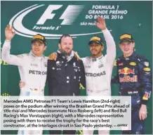  ?? AFPPIX ?? Mercedes AMG Petronas F1 Team’s Lewis Hamilton (2nd-right) poses on the podium after winning the Brazilian Grand Prix ahead of title rival and Mercedes teammate Nico Rosberg (left) and Red Bull Racing’s Max Verstappen (right), with a Mercedes...