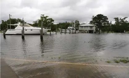  ??  ?? The flooded Cedar Lake Road in Biloxi, Mississipp­i. Photograph: Rogelio V Solis/AP