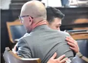  ?? SEAN KRAJACIC/THE KENOSHA NEWS VIA AP, POOL ?? Kyle Rittenhous­e hugs one of his attorneys, Corey Chirafisi, after he is found not guilty on all counts at the Kenosha County Courthouse in Kenosha, Wis., on Friday.