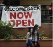  ?? ERIC GAY ?? FILE - In this May 27, 2020, file photo, visitors to the River Walk pass a restaurant that has reopened in San Antonio. Coronaviru­s cases are rising in nearly half the U.S. states, as states are rolling back lockdowns.